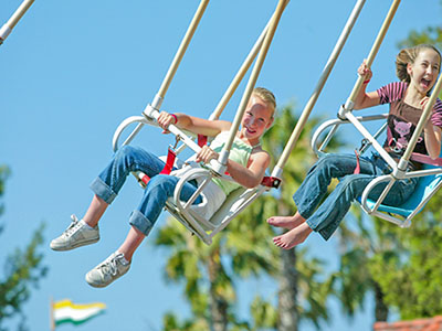 Girls riding on swings