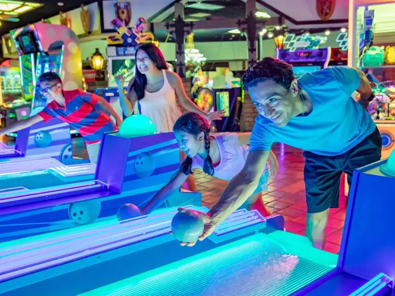 Family play skeeball at Castle Park Arcade