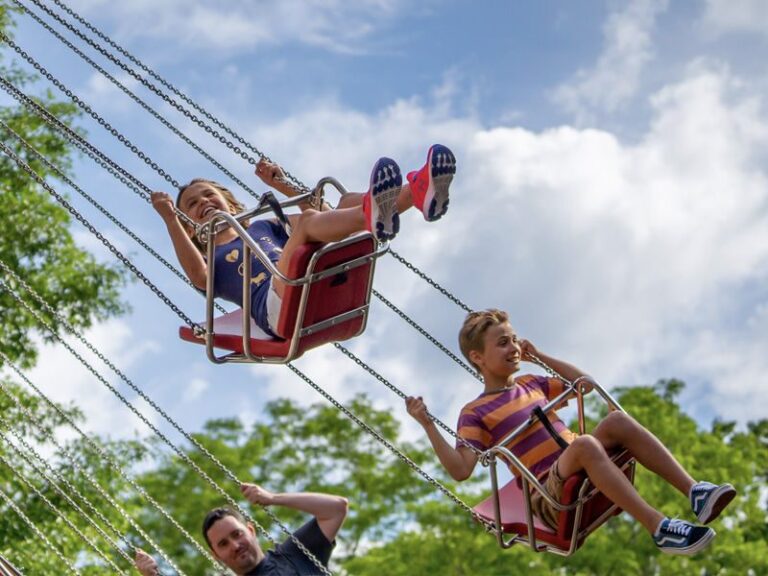kids riding sky swings - Kings Crown